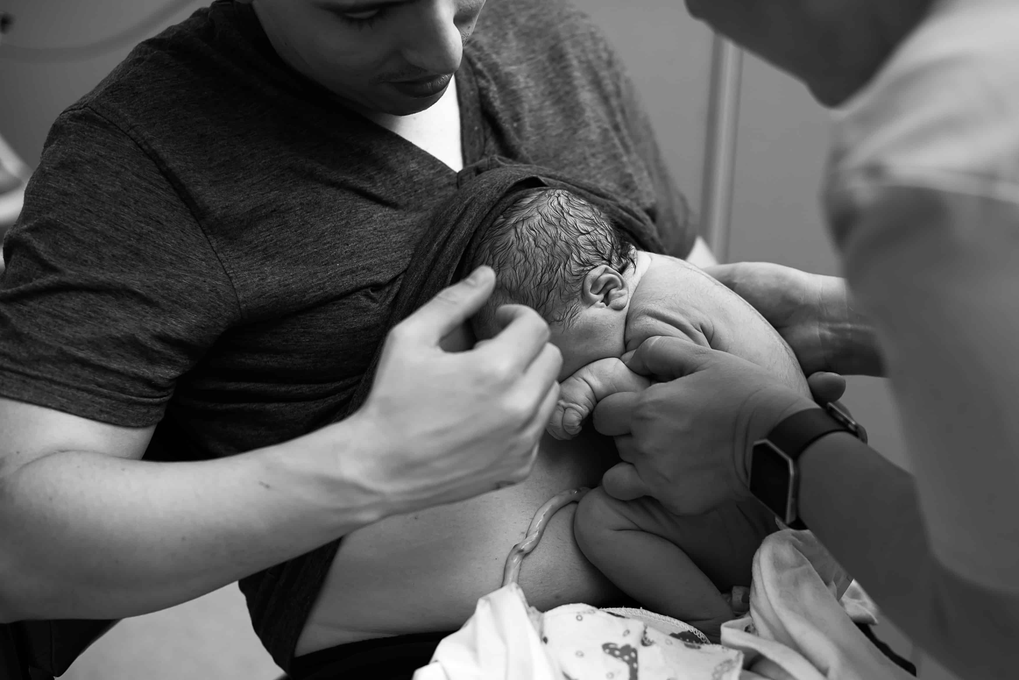 Delayed cord clamping while allowing skin to skin contact with the father. 