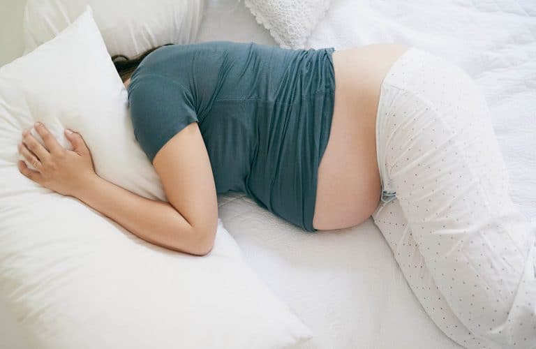 Sleeping when you're pregnant is not easy because it's so uncomfortable and difficult to move. Use these tips to help you sleep better during pregnancy.